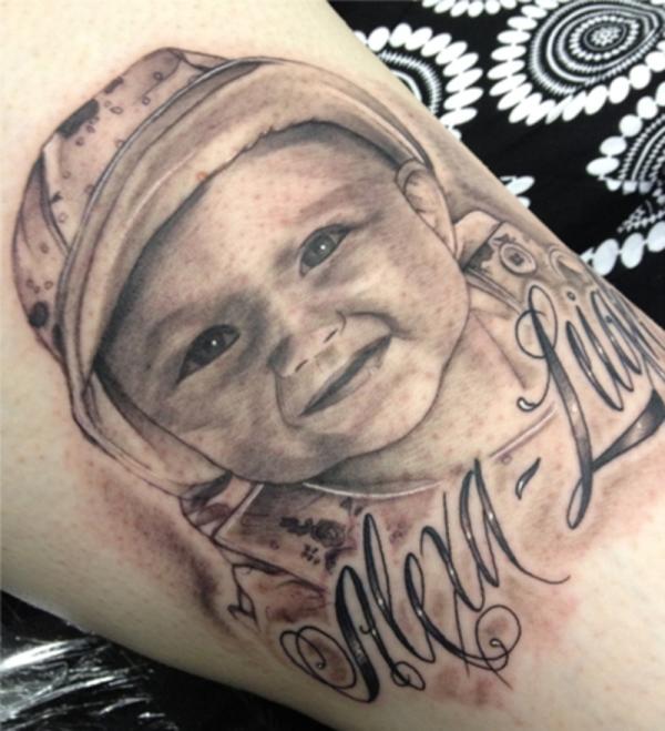 Grey Ink Baby Face Tattoo Design