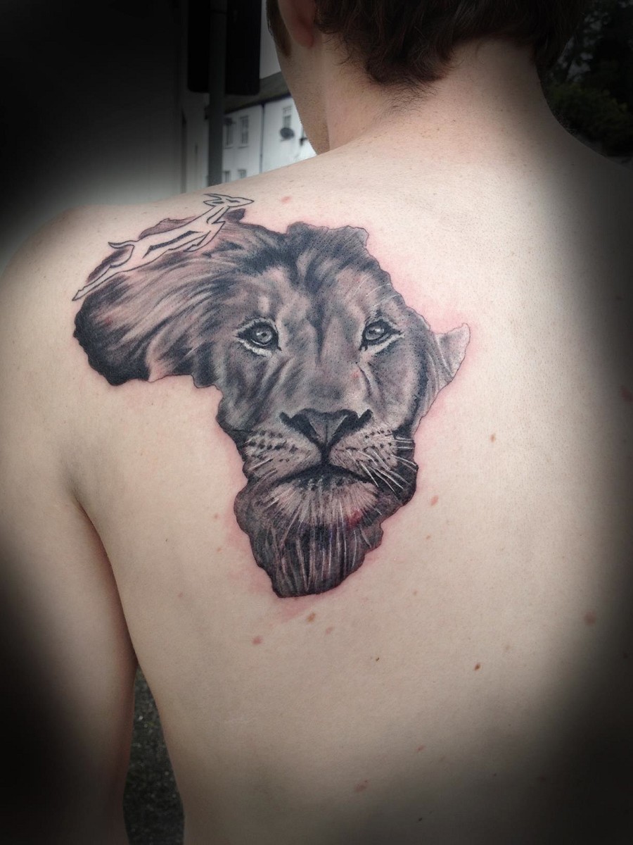Grey Ink Lion Face In Africa Map Tattoo On Man Left Back Shoulder