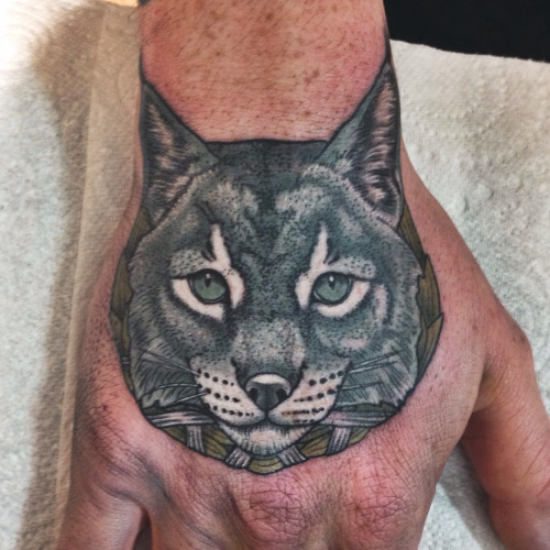 Grey Ink Lynx Head Tattoo On Hand