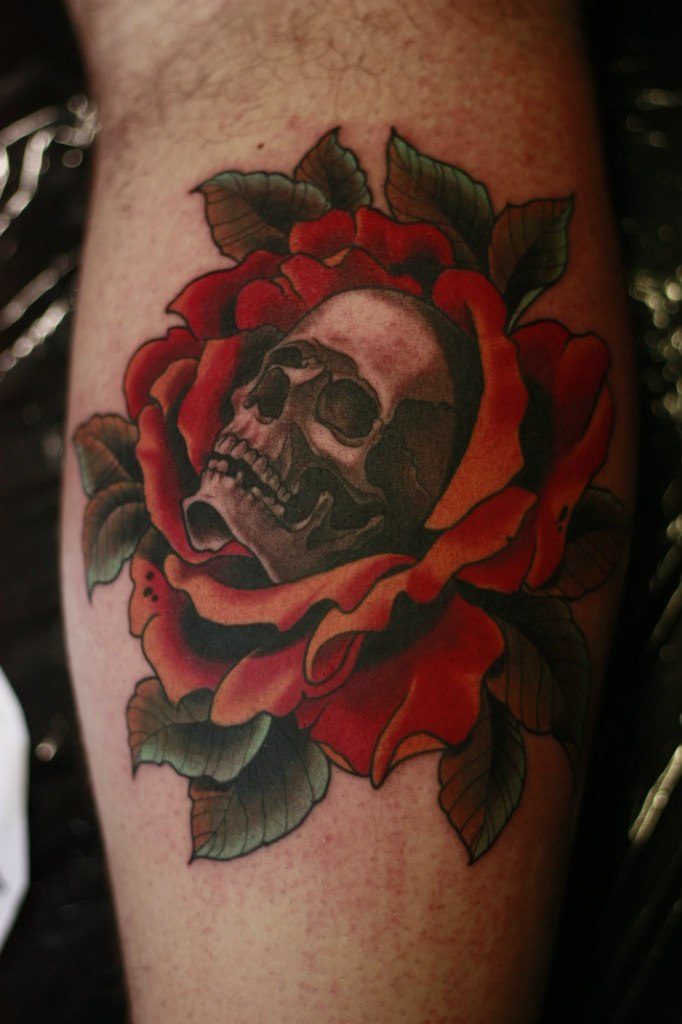 Grey Ink Skull In Red Rose Tattoo On Leg Calf
