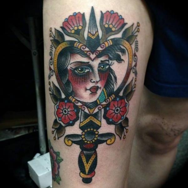 Gypsy Face In Heart Frame With Dagger Tattoo On Thigh
