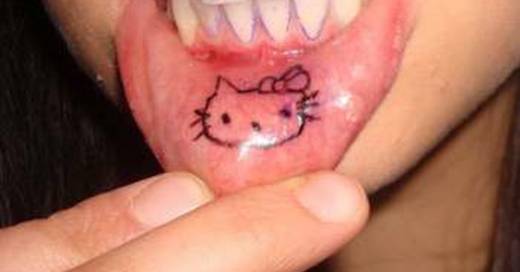 Hello Kitty Head Tattoo On Inner Lip