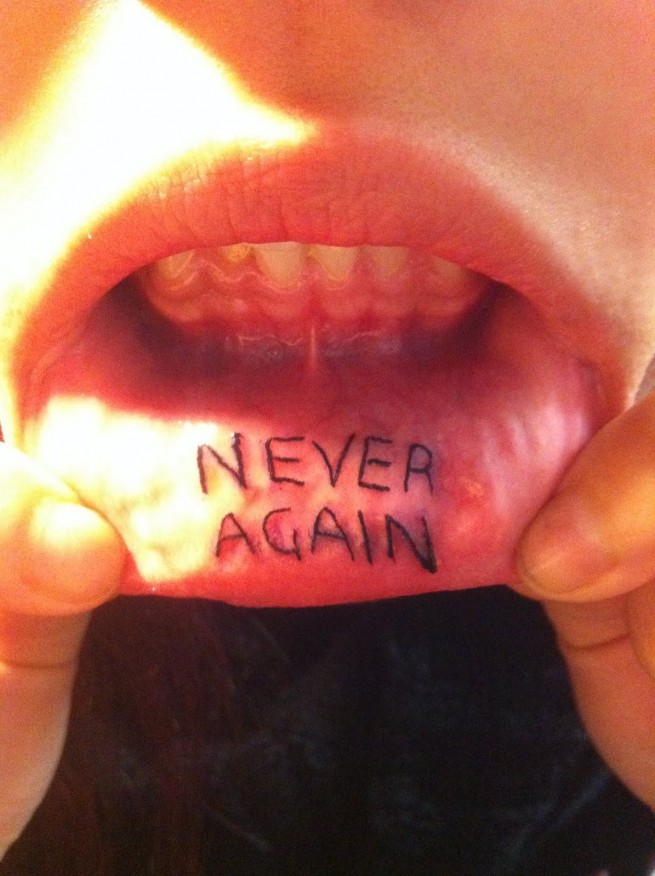 Never Again Lettering Tattoo On Inner Lip