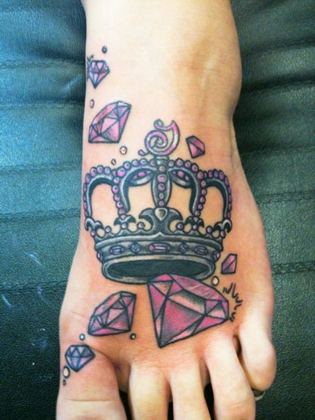 Pink And Black Crown With Diamonds Tattoo On Foot