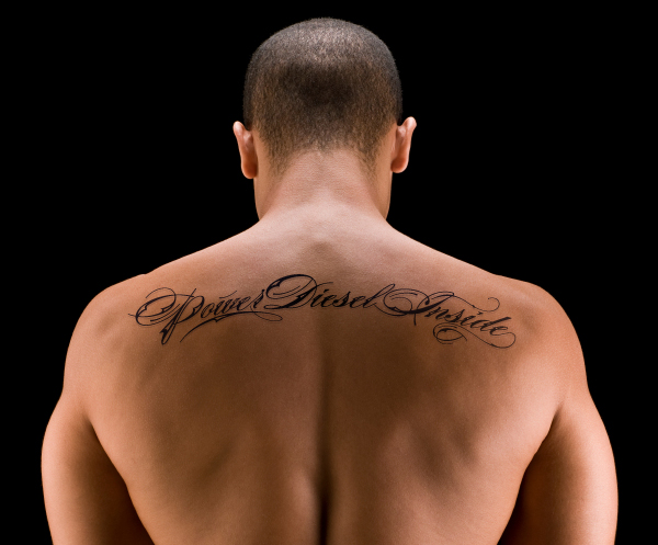 Power Diesel Inside Lettering Tattoo On Man Upper Back