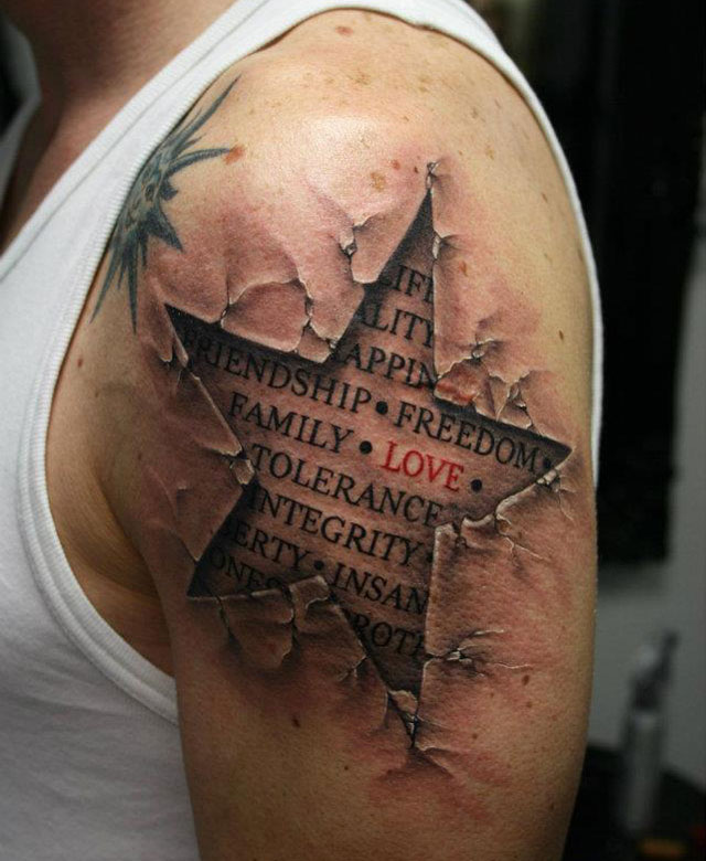 Quote In Ripped Skin Star Tattoo On Man Left Shoulder