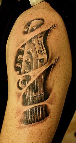 Ripped Skin Guitar Hand Stock Tattoo On Left Shoulder