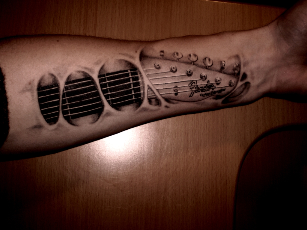 Ripped Skin Guitar Tattoo On Forearm