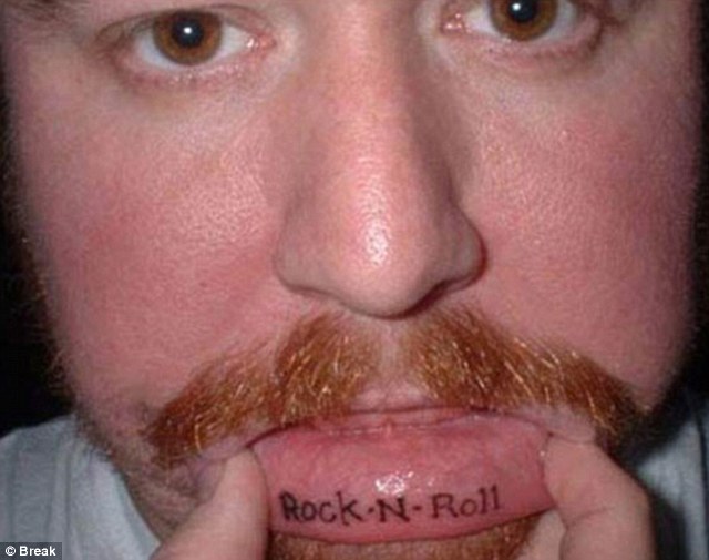 Rock N Roll Lettering Tattoo On Man Inner Lip