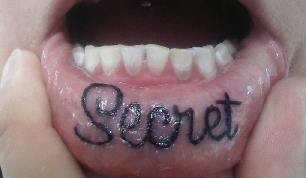 Secret Lettering Tattoo On Inner Lip