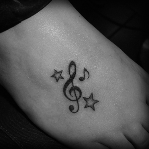 Stars And Violin Key Tattoo On Right Foot