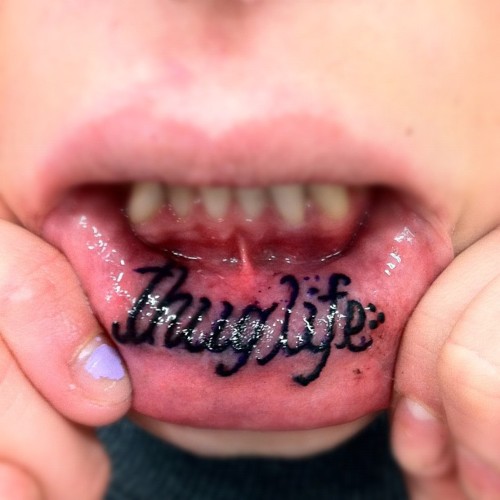 Thug life Lettering Tattoo On Inner Lip