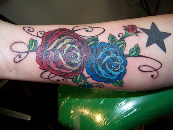 Two Blue And Red Roses Tattoo On Forearm