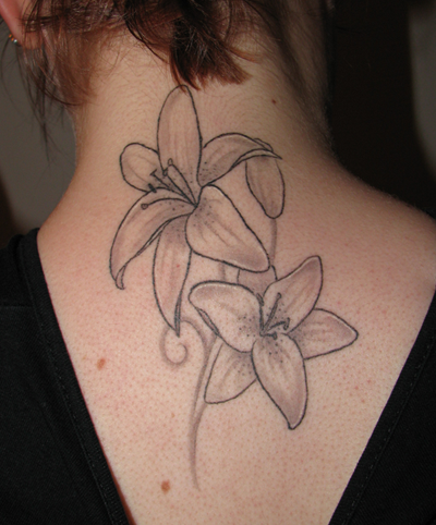 Two Lily Flowers Tattoo On Girl Upper Back