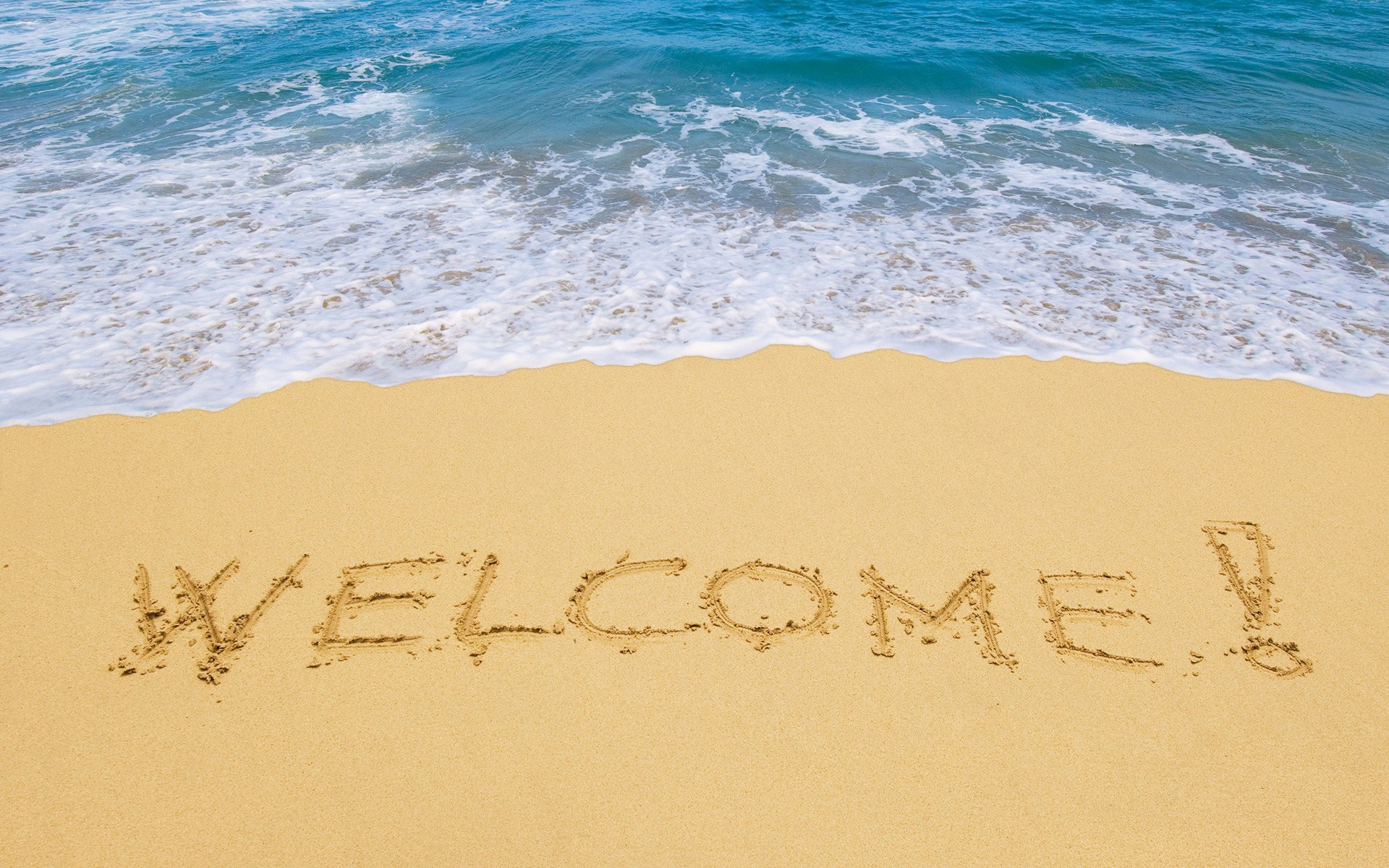 Welcome Written On Beach Sand