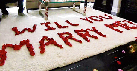 Will You Marry Me Written With Flowers On Bed
