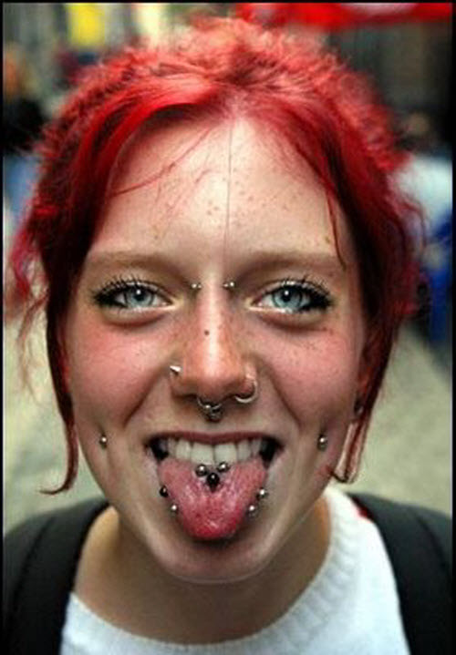 Woman Showing Her Face Piercings And Tongue Piercing