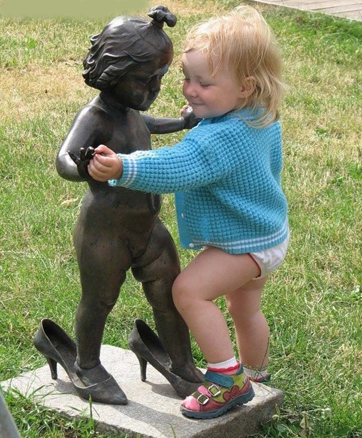 Funny Baby Girl Dancing With Statute