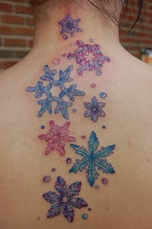Amazing Colorful Snowflakes Tattoo On Upper Back