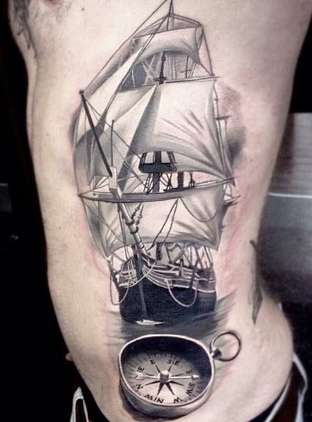 Black And Grey 3D Ship With Compass Tattoo On Man Side Rib