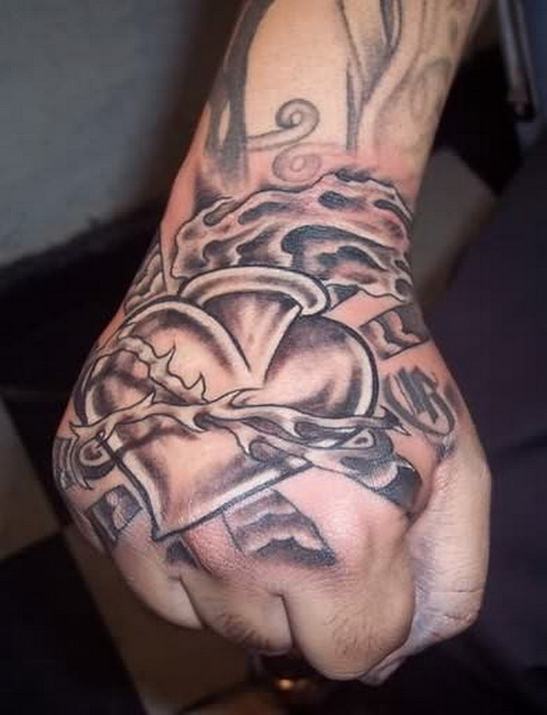 Black And Grey Sacred Heart With Barbed Tattoo On Hand