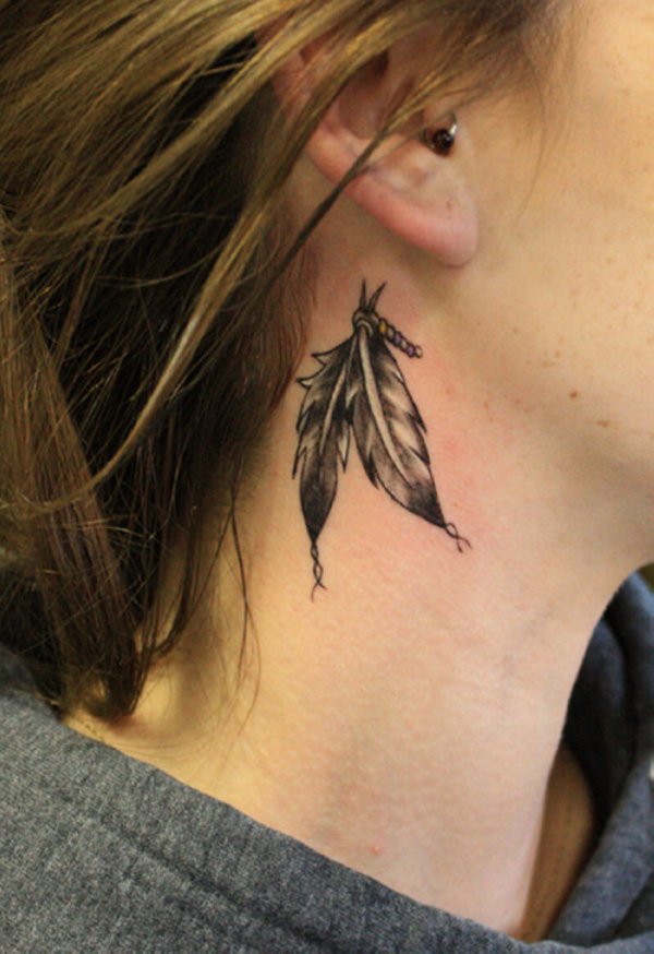 Black And Grey Two Feather Tattoo On Girl Behind The Ear
