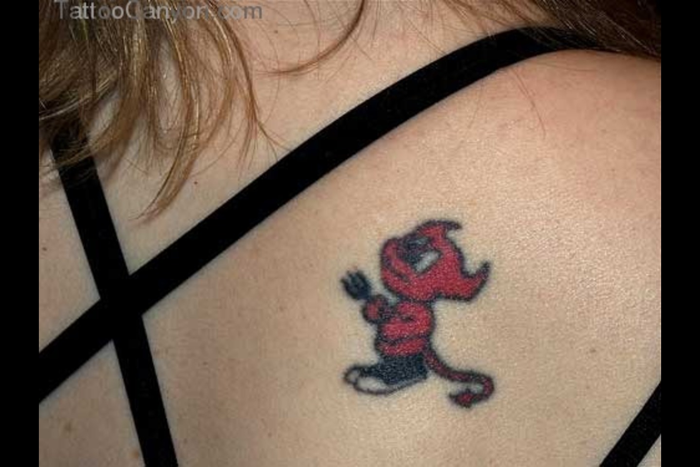 Black And Red Baby Devil Tattoo On Girl Upper Back