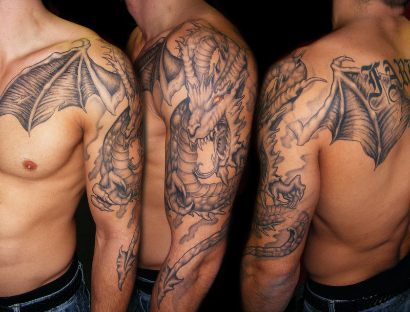 Black Ink Dragon Tattoo On Man Left Full Arm