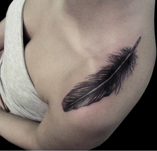 Black Ink Feather Tattoo On Girl Left Shoulder