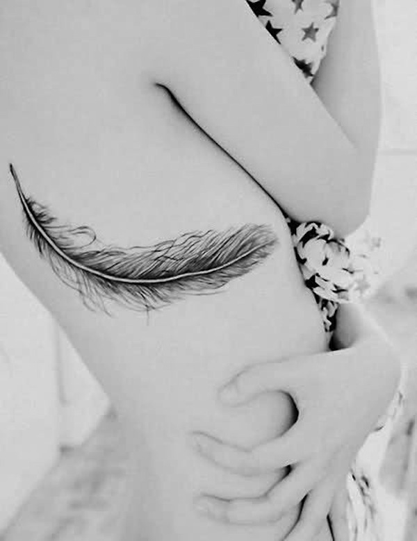 Black Ink Feather Tattoo On Girl Upper Rib