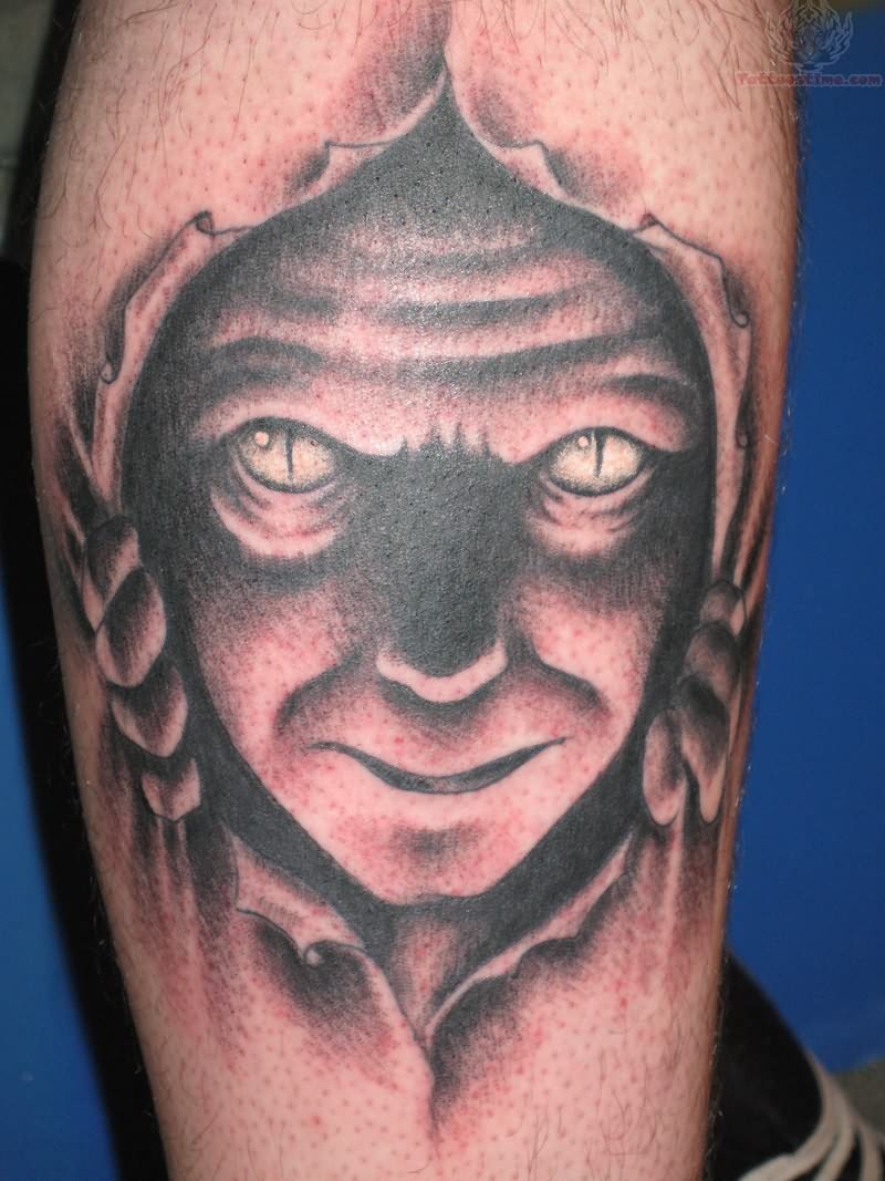 Black Ink Ripped Skin Devil Face Tattoo On Leg Calf
