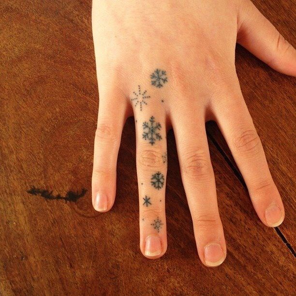 Black Ink Snowflakes Tattoo On Finger