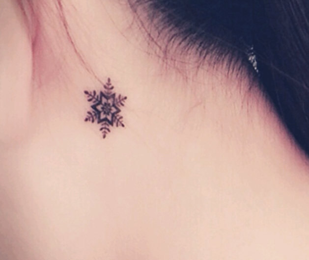 Black Little Snowflake Tattoo On Girl Behind The Ear