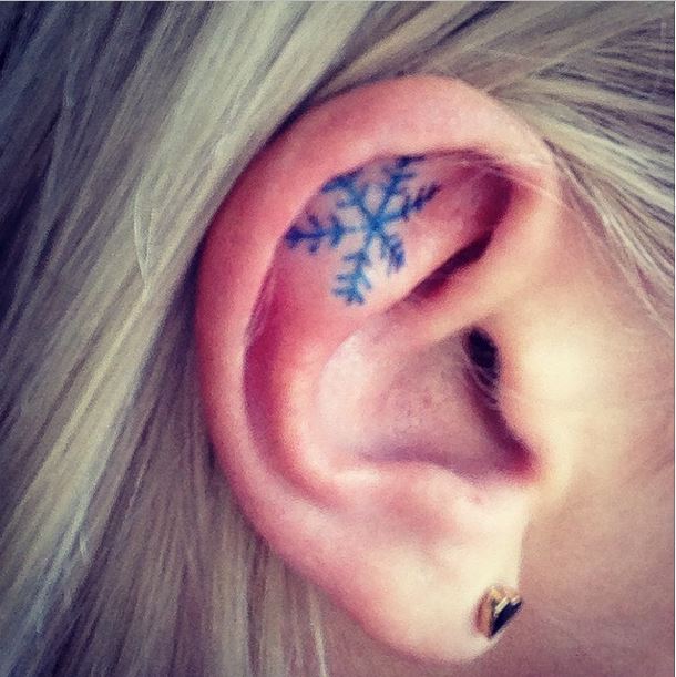 Black Snowflake Tattoo On Girl Inside Ear