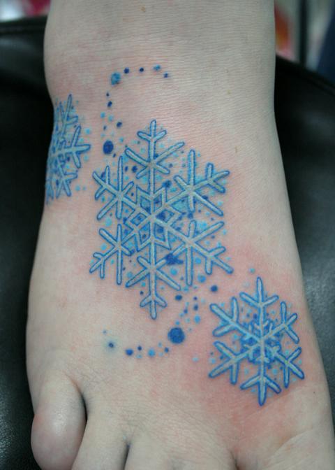 Blue Ink Three Snowflake Tattoo On Foot By Debo
