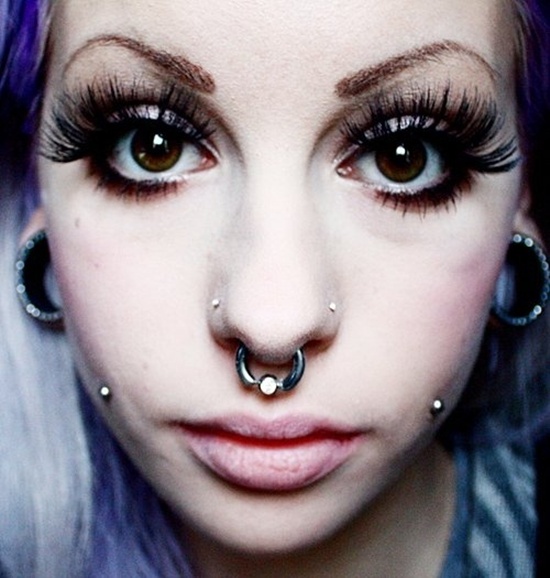 Cheek Piercings With Silver Studs And Septum Piercing