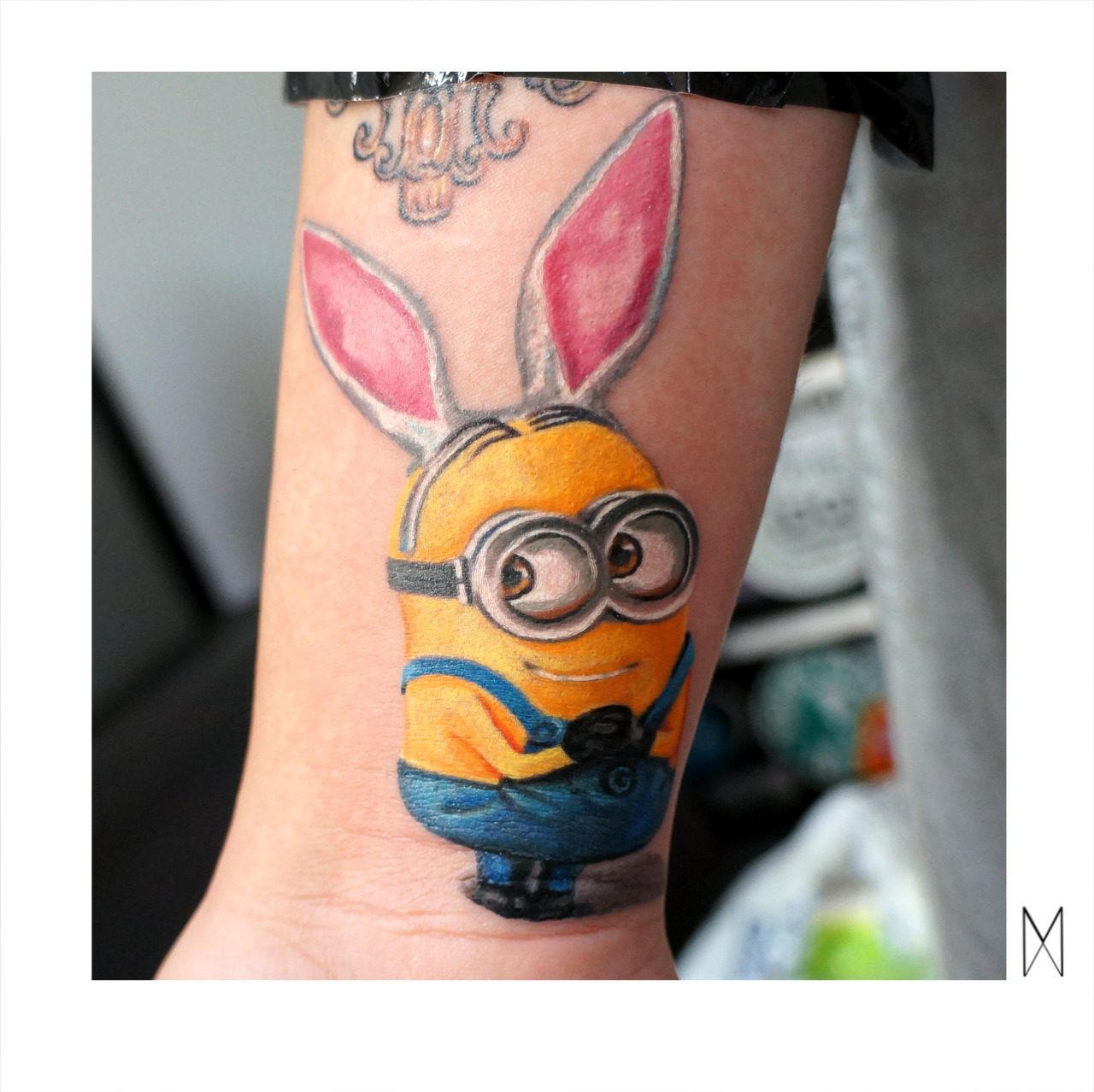 Colorful Minion With Rabbit Ears Tattoo Design
