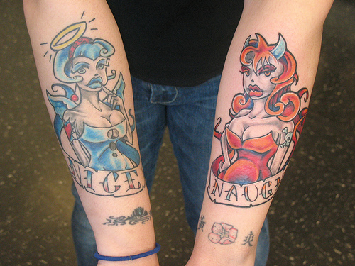 Devil And Angel Girl With Banner Tattoo On Both Forearm
