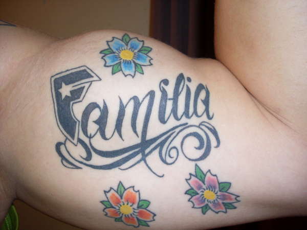 Flowers And Familia Tattoo On Bicep