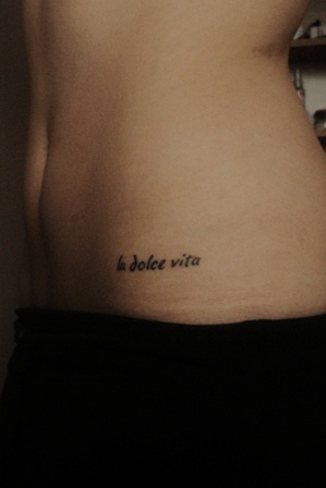 La Dolce Vita Lettering Tattoo On Front Hip