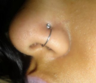 Left Nostril Piercing With Silver Hoop Ring