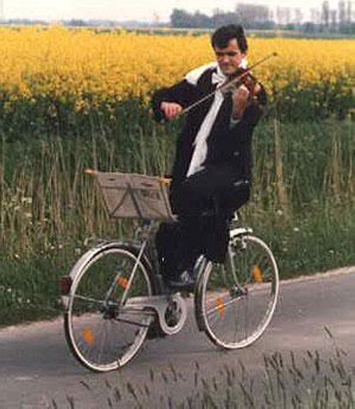 Man Riding Bicycle And Playing Violin Funny Picture