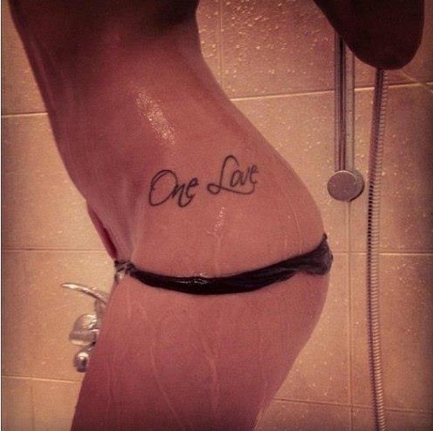 One Love Lettering Tattoo On Girl Side Hip