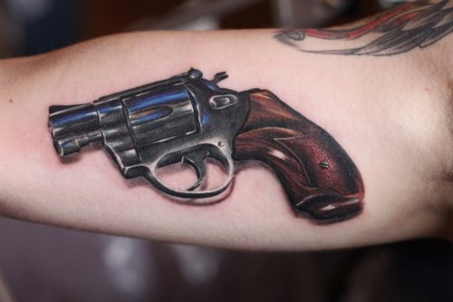 Realistic 3D Gun Tattoo On Bicep