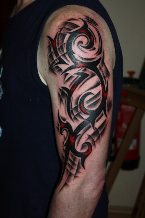Red And Black Tribal Design Tattoo On Left Arm By Marc Riedel