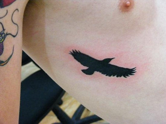 Silhouette Flying Crow Tattoo On Upper Side Rib