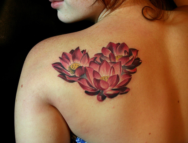Three Lotus Flowers Tattoo On Girl Left Back Shoulder