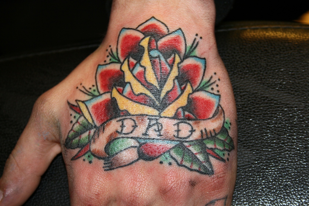 Traditional Red Rose With Banner Tattoo On Hand