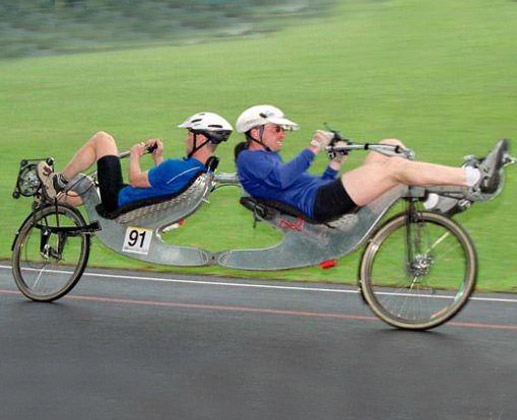 Two People Riding Funny Bicycle Picture