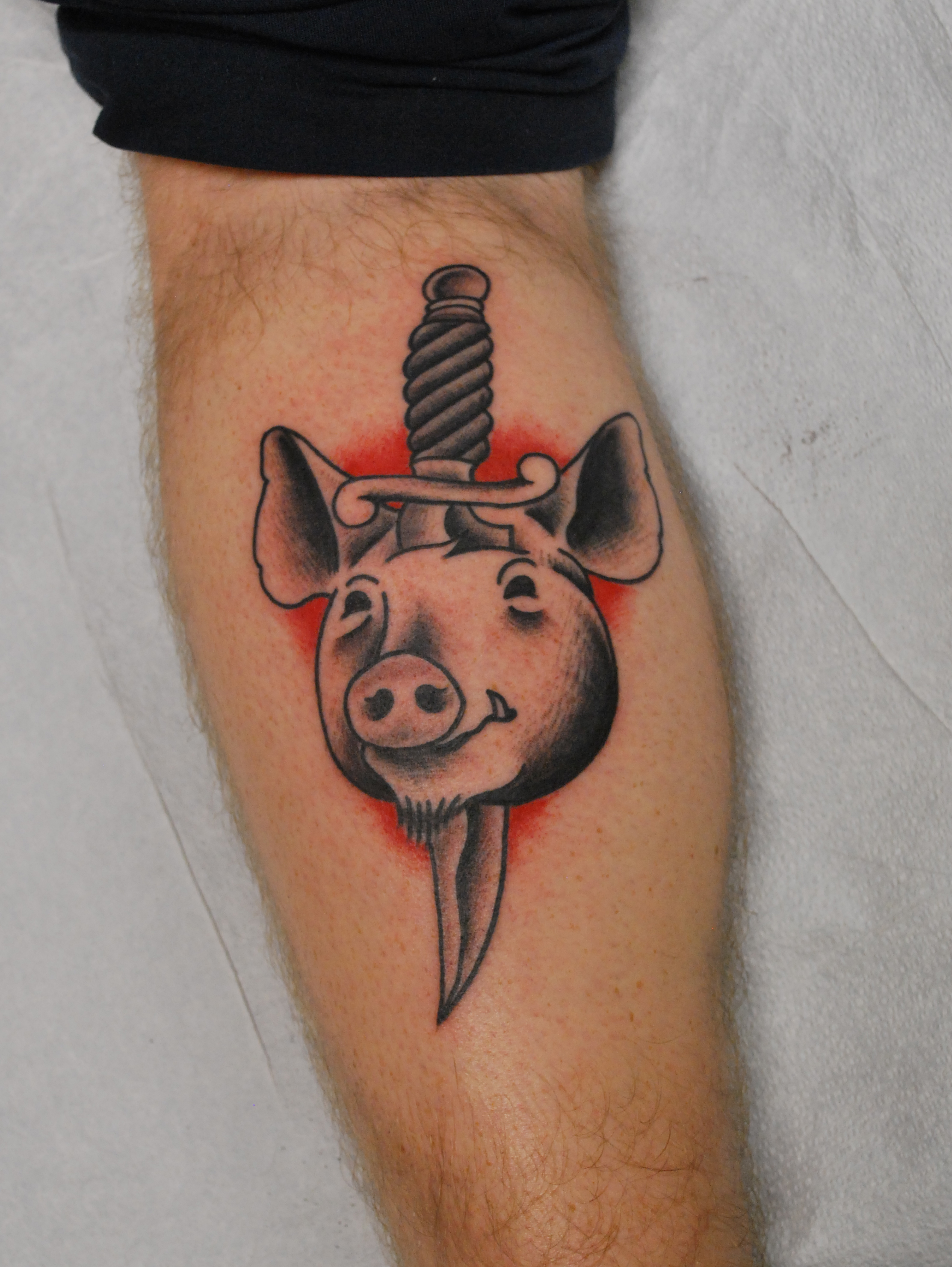 Black Ink Dagger In Pig Head Tattoo Design